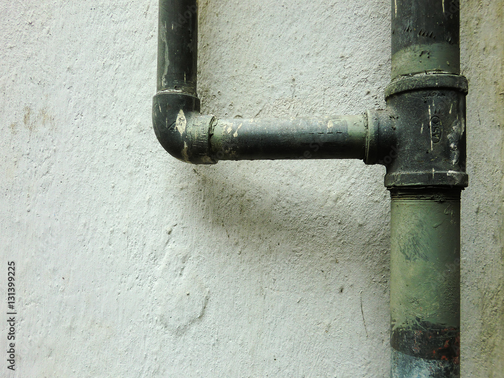 Urban ghetto pipe plumbing against grungy wall texture Urban ghetto pipe plumbing against grungy wall texture