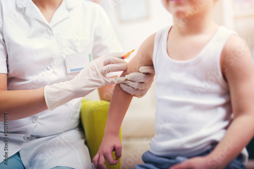 Photos Pediatrician makes vaccination to small boy