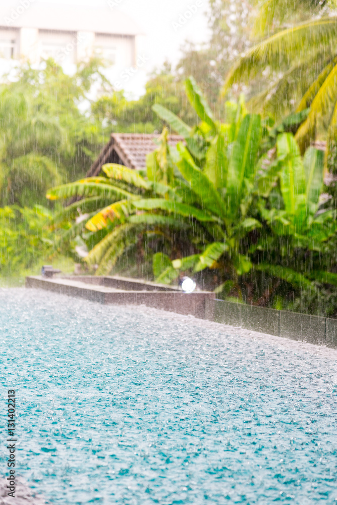 (torrent) Rain falling on surface Blue water in swimming  pool a