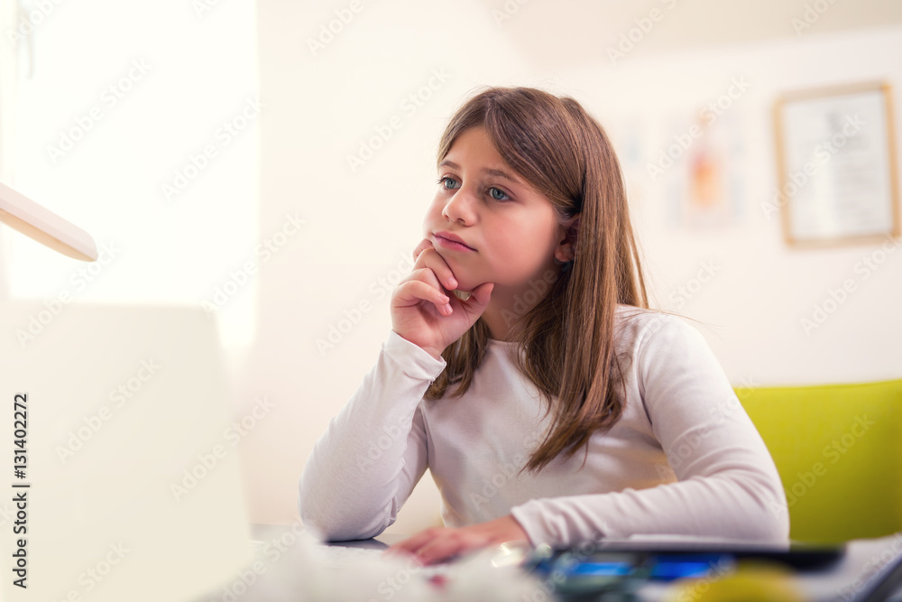 Beautiful girl working on her school project at home. Beautiful girl working on her school project at home.