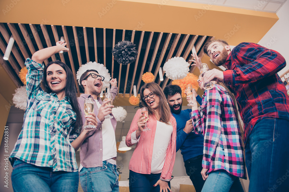 Obraz premium Party time. Six attractive happy laughing friends, boys and girl