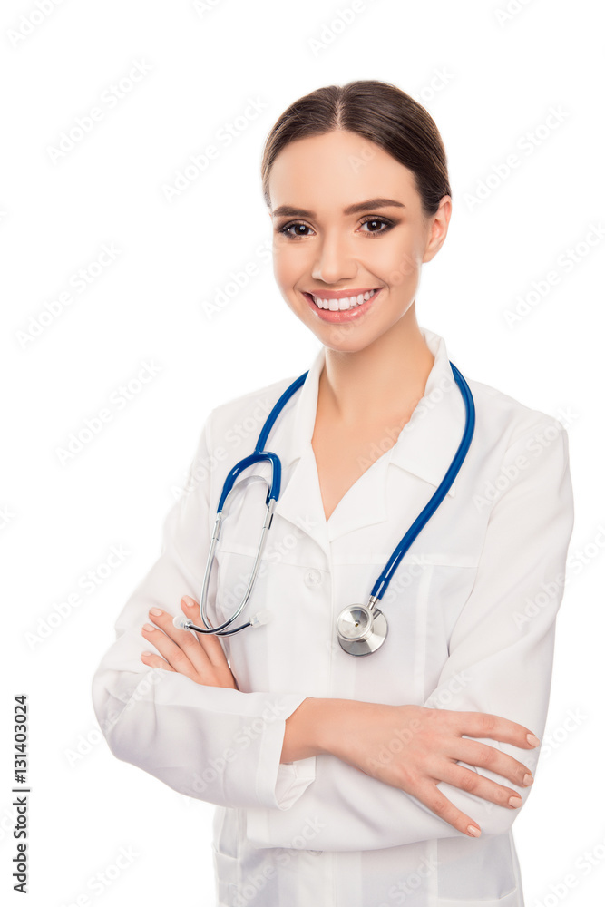 Portrait of pretty female doctor with beaming smile and crossed Portrait of pretty female doctor with beaming smile and crossed