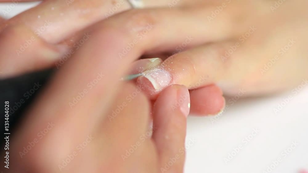 The procedure of painting nails in the spa salon.Manicure procedure in the beauty salon on white background The procedure of painting nails in the spa salon.Manicure procedure in the beauty salon on white background