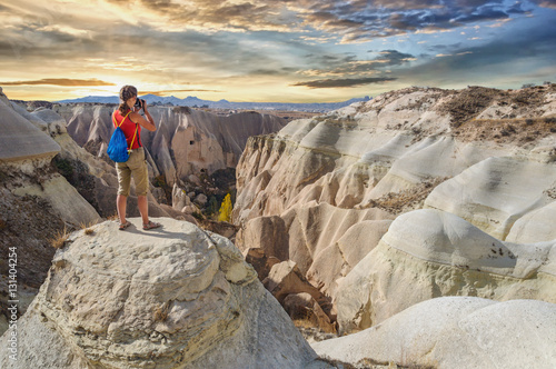 Young woman take photo majestic sunset in Cappadocia