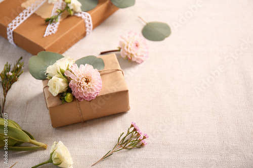 Handcrafted gift box with flowers on table © Africa Studio