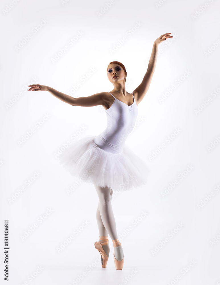 Obraz premium Young beautiful ballet dancer on a white background