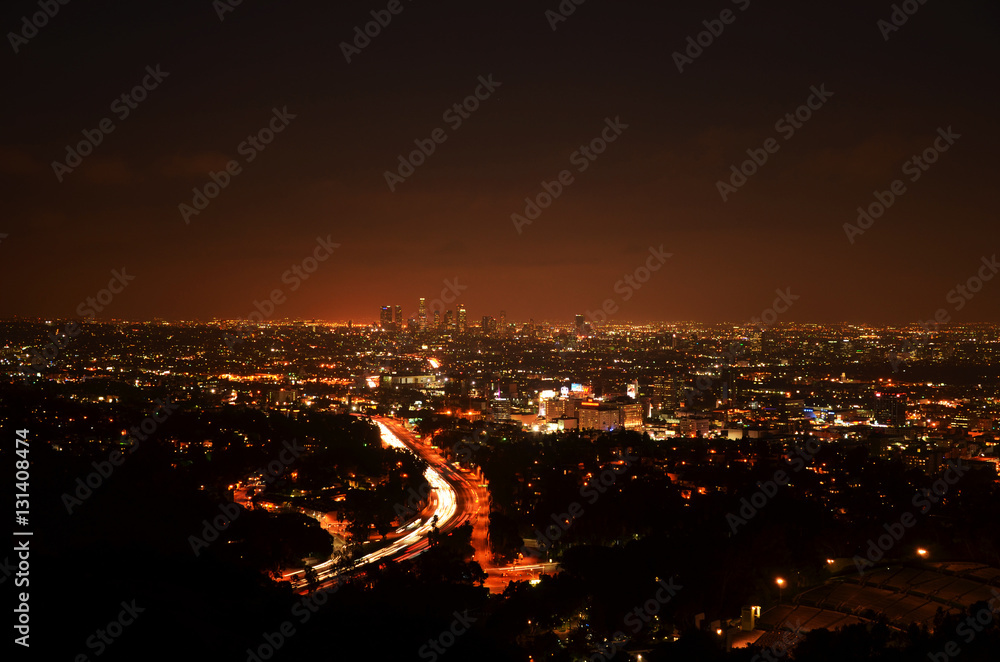 Fototapeta premium Los Angeles Skyline of Downtown with skyscrapers, urban buildings and traffic on Interstate 101 at night