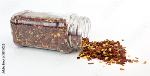 Jar of crushed red pepper. Isolated. Horizontal.