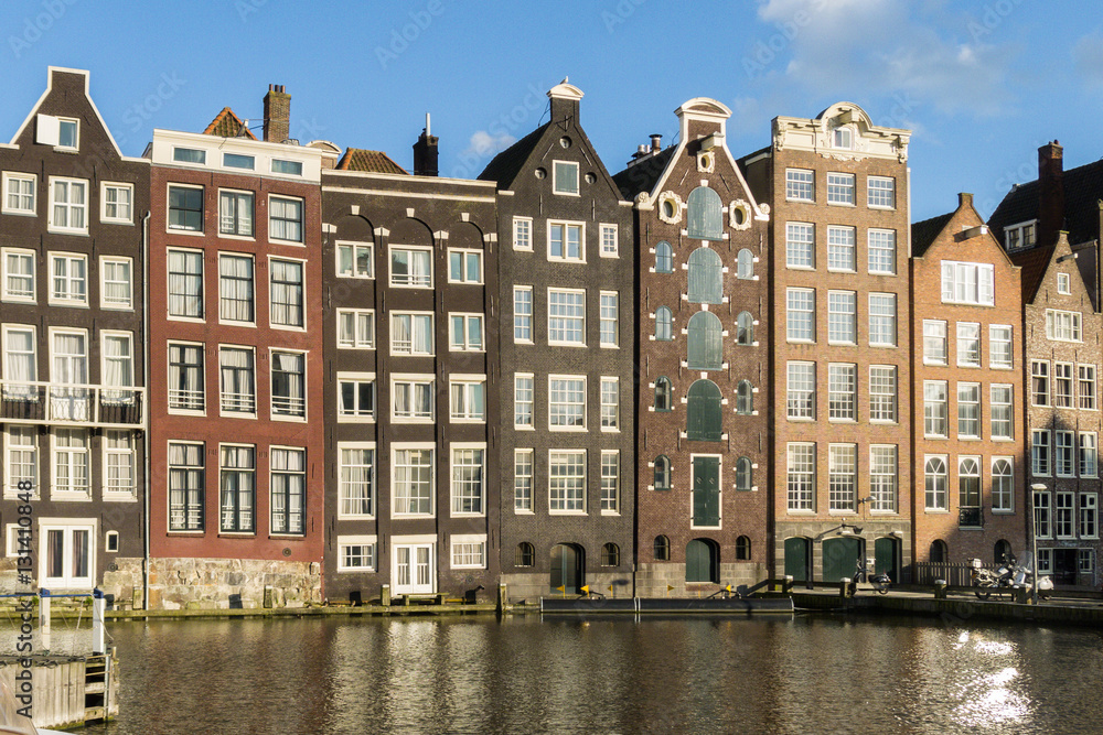 Houses in in a street by a canal in Amsterdam