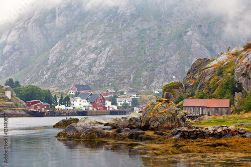 Norway village on a fjord. Nordic cloudy summer day.