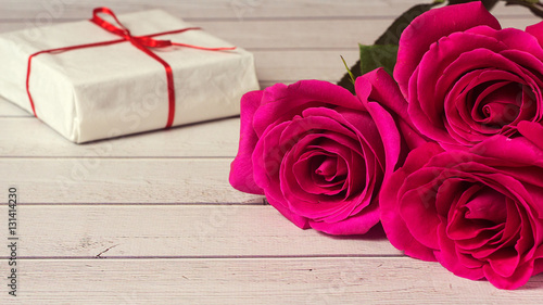 Romantic composition with rose flowers and gift St. Valentines Day background