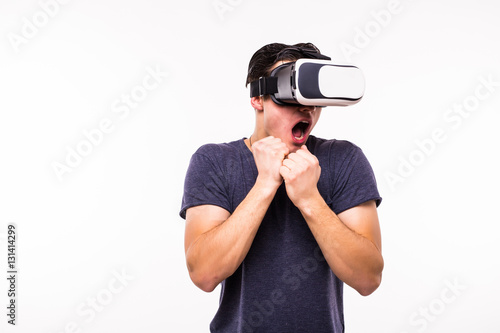 portrait of young excited man experiencing virtual reality isolated on white background