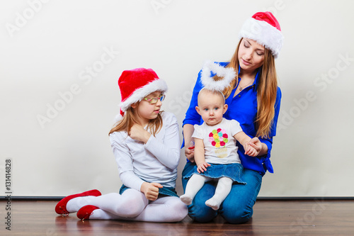 Mother and daughters in christmas outfit