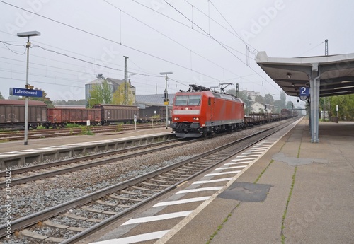 freight train passing through a smal train station in Lahr, Baden Germany