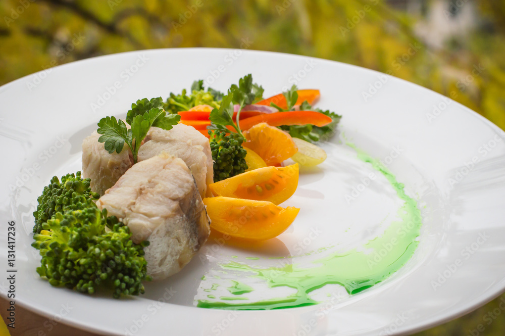 Boiled seabass with steamed vegetables - totally healthy meal. Close-up Boiled seabass with steamed vegetables - totally healthy meal. Close-up