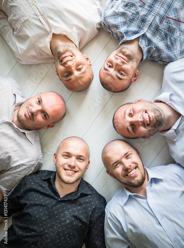 Group portrait of young bald men photo