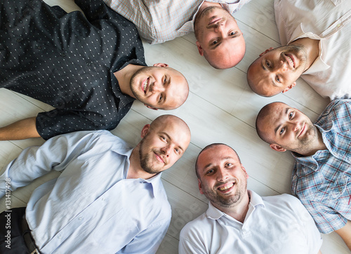 Group portrait of young bald men photo