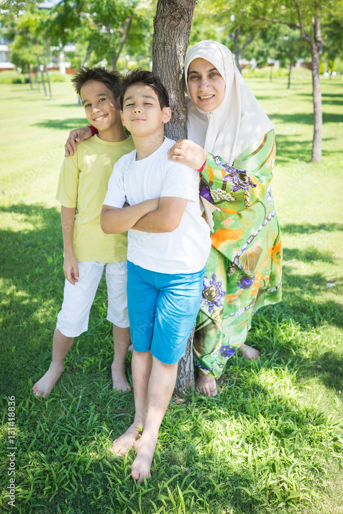 Fototapeta premium Muslim Arabic mother and kid in nature