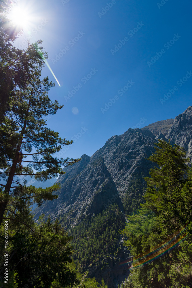 Samaria Gorge. Crete. Greece. Lens flare on the blue sky. Samaria Gorge. Crete. Greece. Lens flare on the blue sky.