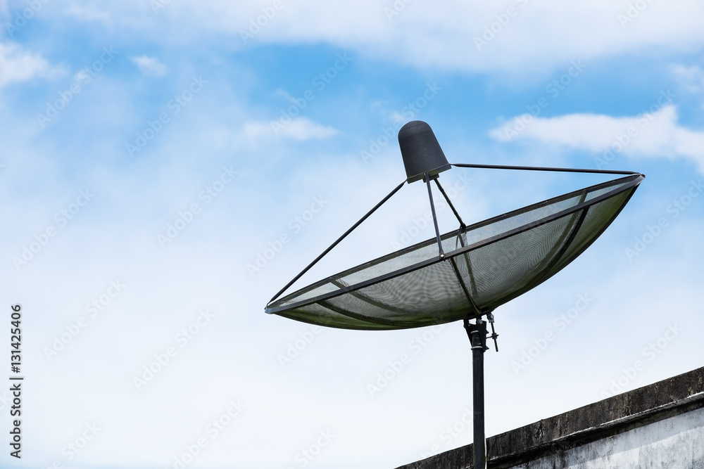 Satellite dish on roof with blue sky and some cloud. Satellite dish on roof with blue sky and some cloud.