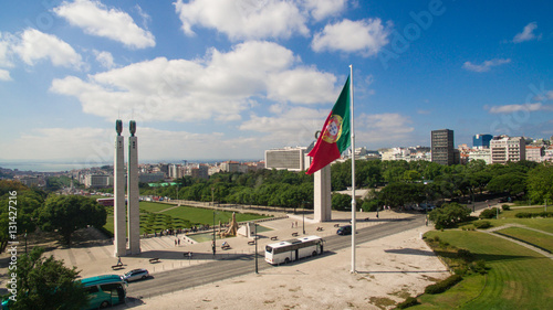 Quadro su tela Portuguese Waving Flag in Eduardo VII Park in Lisbon, Portugal aerial view
