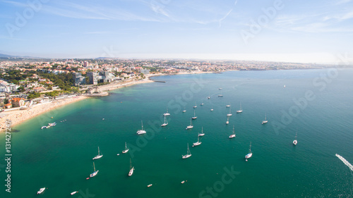 yacht near beautiful beach and marina of Cascais Portugal aerial view
