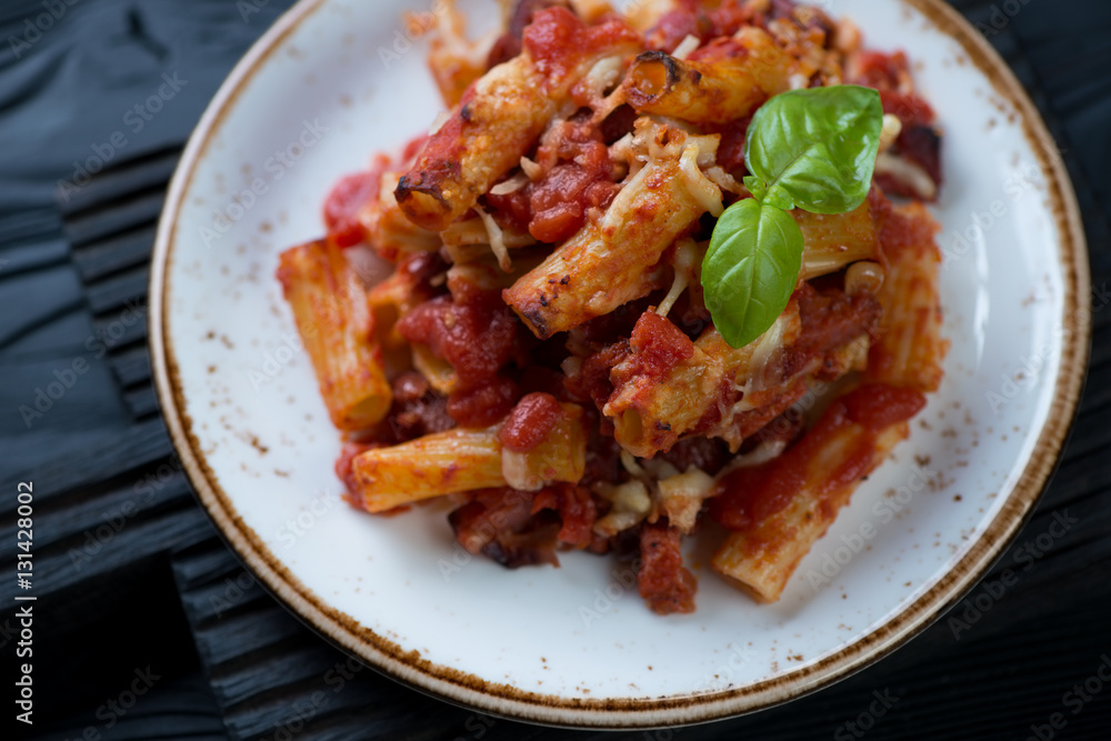 Closeup of italian ziti served on a glass plate, selective focus Closeup of italian ziti served on a glass plate, selective focus
