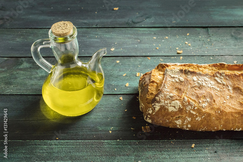 Olive oil pitcher and loaf of bread with copyspace