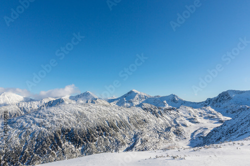 Bright winter scenery in the mountains, with frost and rocks covered with fresh snow © Calin Tatu