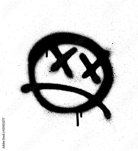 Graffiti emoticon face sprayed in black on white