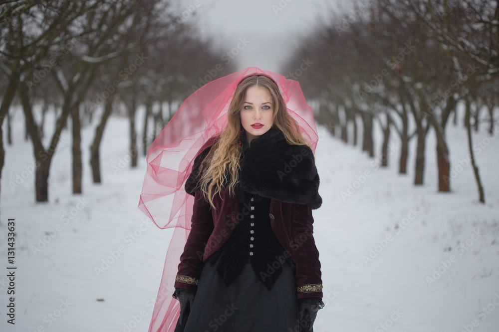 girl in a red veil on the snow in the winter girl in a red veil on the snow in the winter