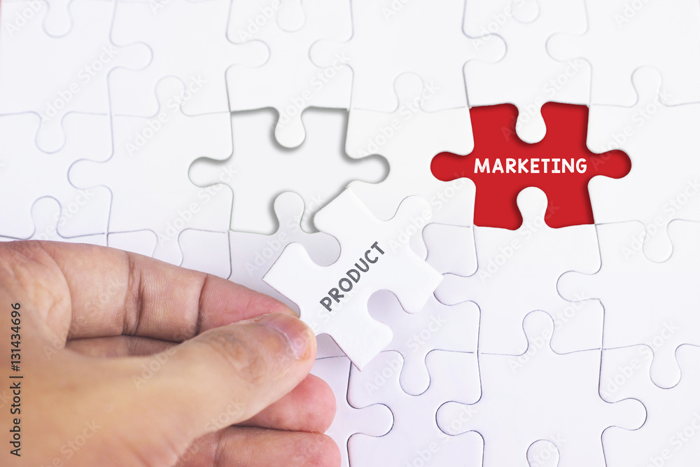 Fototapeta premium Business Concept - Female hand and missing puzzle with PRODUCT MARKETING