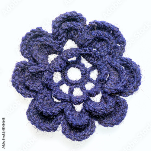 homemade crocheted blue flower isolated on white background photo