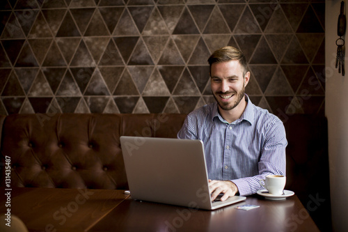 Young man sitting in cafe a...