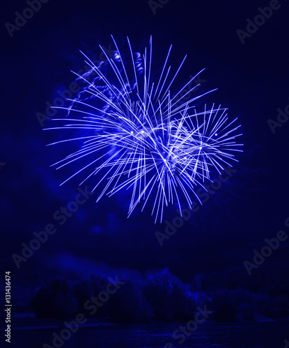 Awesome blue fireworks at night on the river 