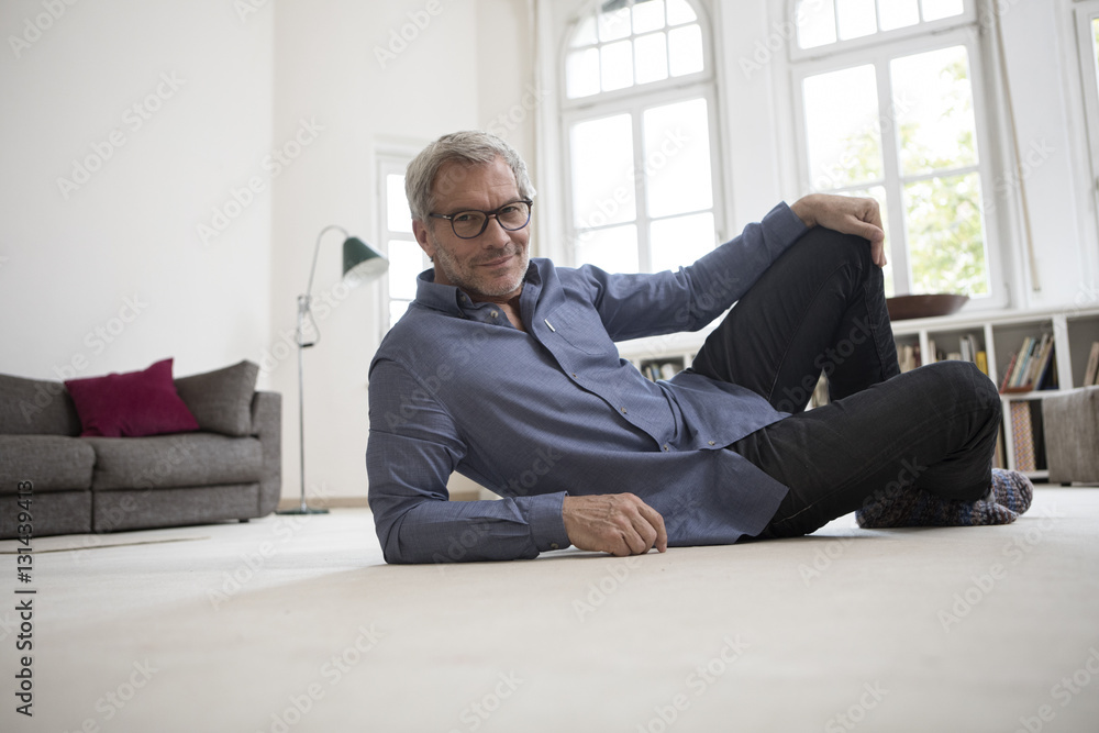 Relaxed mature man at home lying on floor Relaxed mature man at home lying on floor