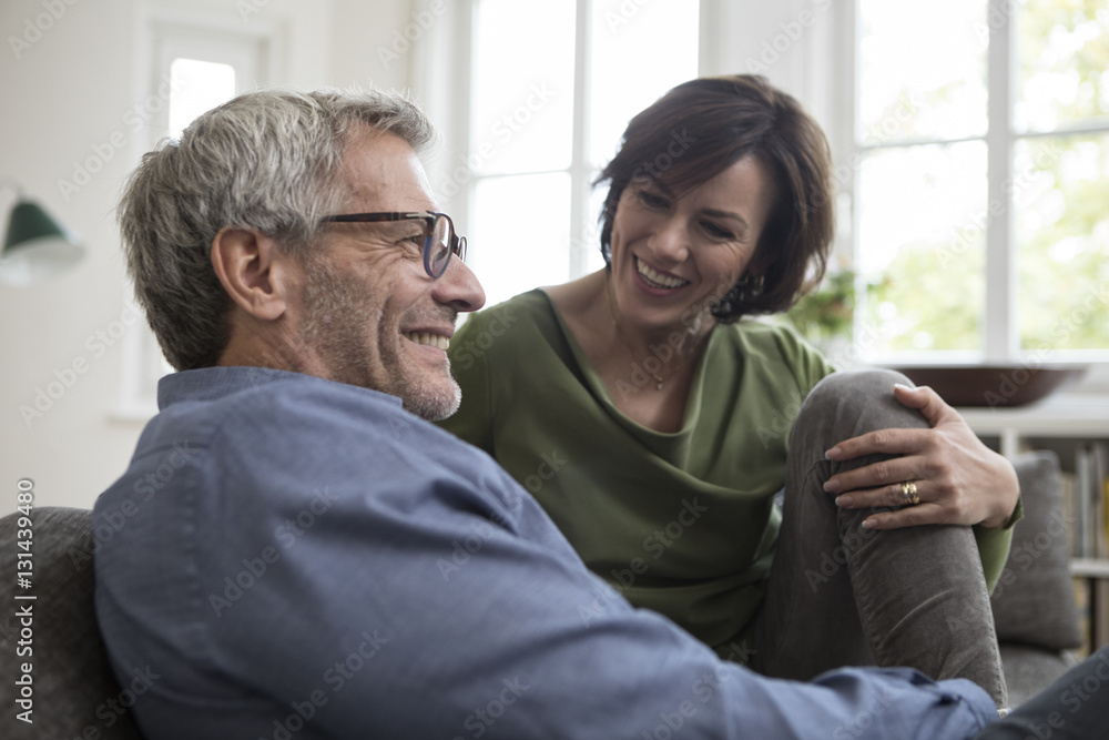 Smiling mature couple at home on the sofa Smiling mature couple at home on the sofa