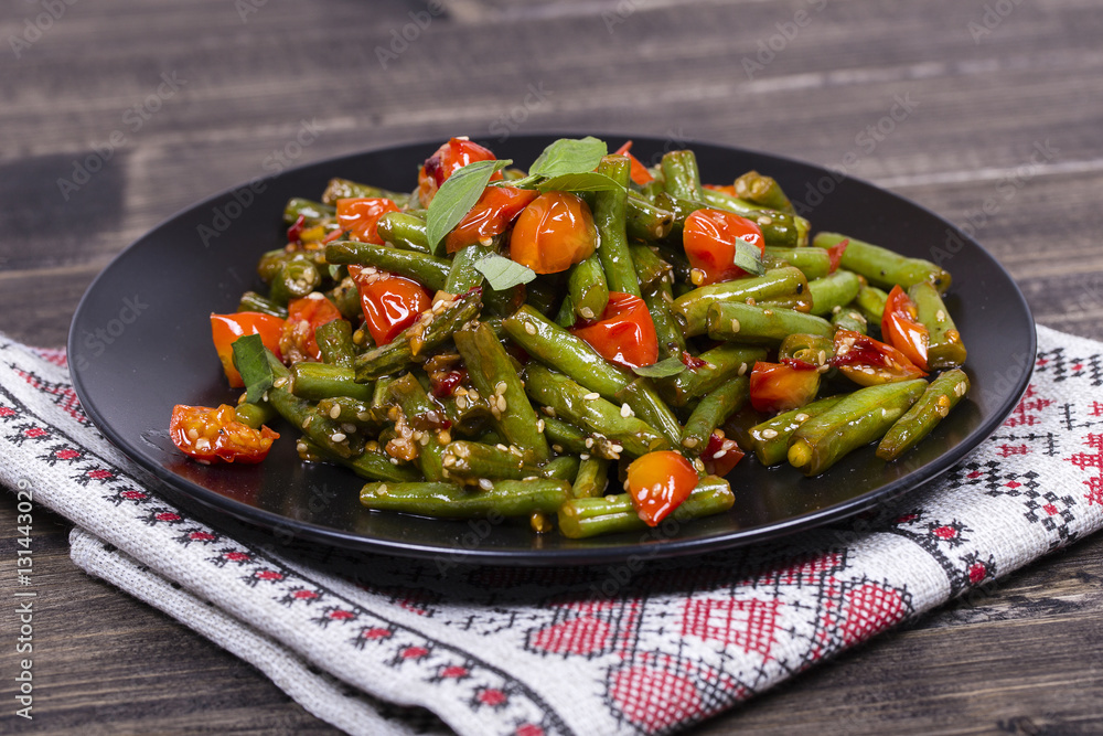 Healthy green beans, red cherry tomato with sesame seeds Healthy green beans, red cherry tomato with sesame seeds
