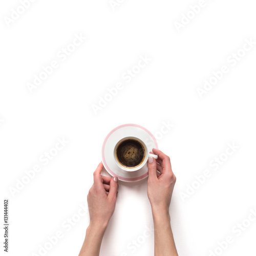 Female(woman) hand hold a white espresso cup with coffee isolate