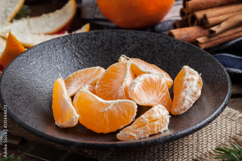 Peeled tangerine on the wooden table. Peeled tangerine on the wooden table.