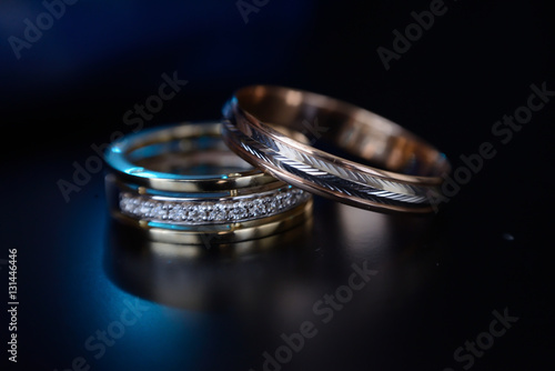 Beautiful wedding golden rings on dark background