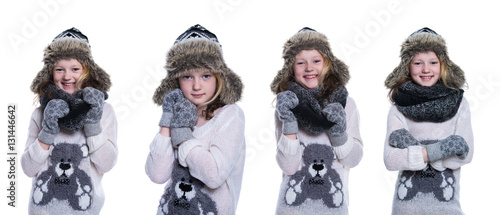 Happy cute kid posing in the studio. Wearing winter clothes. Knitted woolen sweater and mittens. Ear flaps fur cap. Isolated on white background. Composite image.