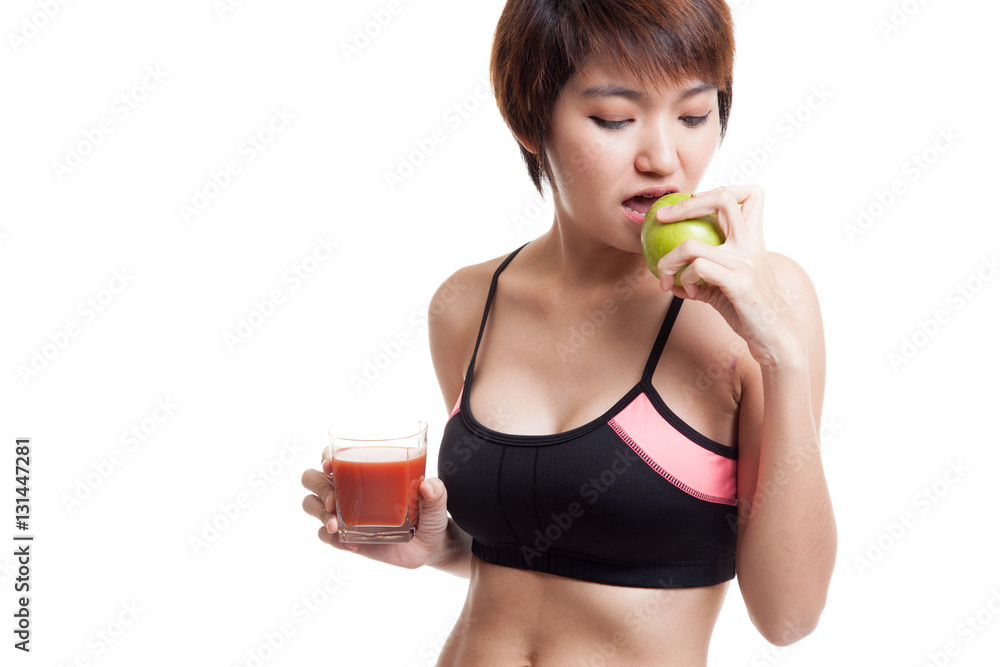 Beautiful healthy Asian girl with tomato juice and apple. Beautiful healthy Asian girl with tomato juice and apple.