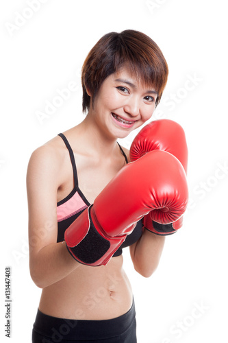 Beautiful healthy Asian girl with red boxing glove. © halfbottle