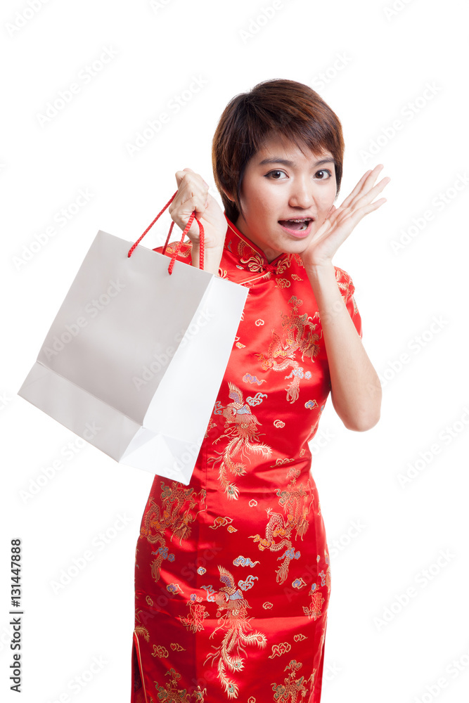 Asian girl in chinese cheongsam dress with shopping bag. Asian girl in chinese cheongsam dress with shopping bag.