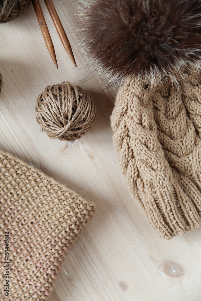 Fototapeta premium tangles of thread and knit cap on the table