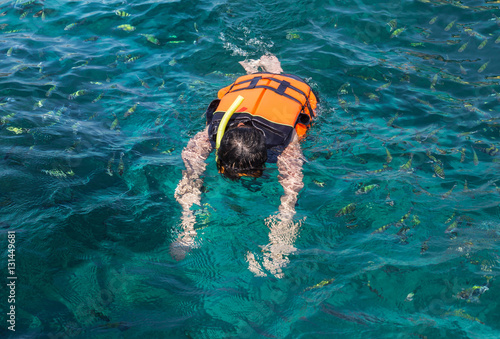 the man snorkeling with life jackets in andaman sea at phi phi islands, Thailand