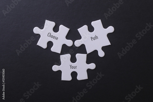 White puzzle on black background with Choose Your Path Word.