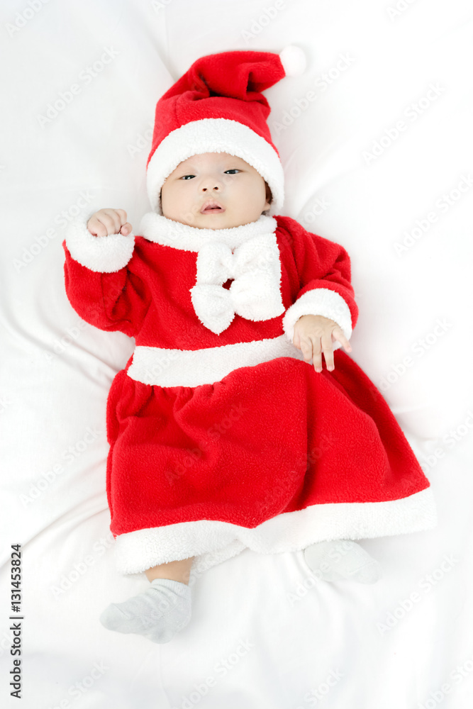 Portrait of adorable baby girl with santa costume. Isolated on w