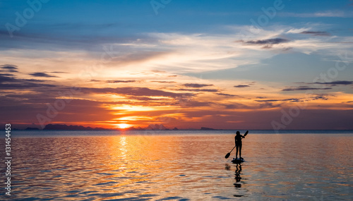 Girl on the paddleboard on the tropical island photo